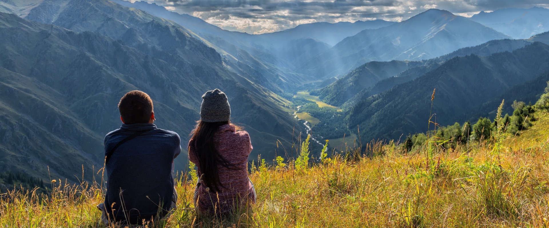 Couple observing mountain range.