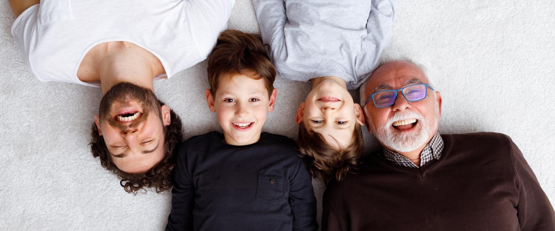 Family laying on carpet.