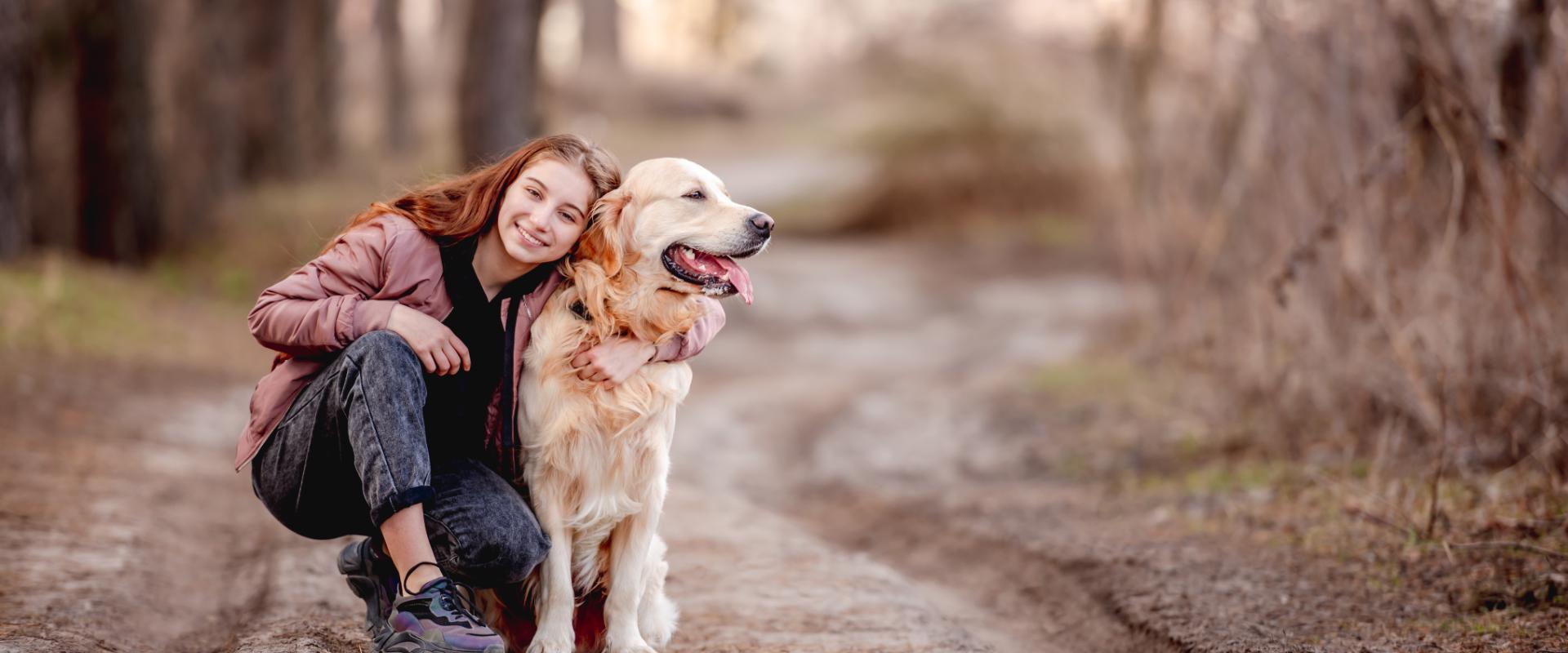 Teenager walking dog'